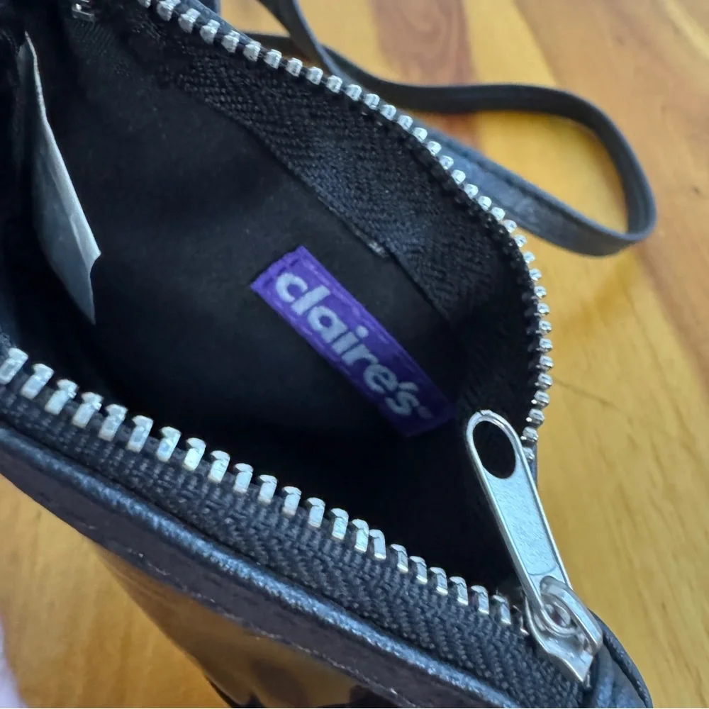 Claire’s black‎ faux leather eyes lashes crossbody